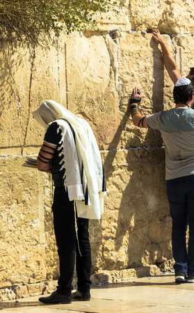 Unidentified jewish worshiper in  tallith and tefillin praying at the Wailing Wall an important jewish religious site. Jerusalem. Israelのeditorial素材