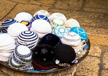 Jewish religious caps yarmulke  on the stone pavement near  souvenir shop in the jewish quarter of the old city. Jerusalem. Israelの写真素材