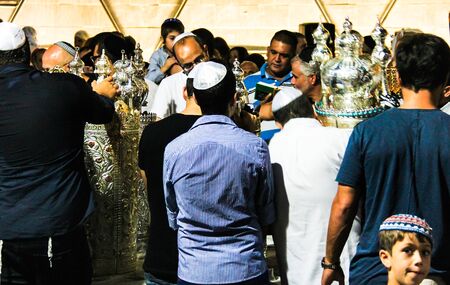 Unidentified jewish men praying on ceremony of Simhath Torah is a celebration marking the conclusion of the annual cycle of public Torah readings, and the beginning of a new cycle. Tel Aviv. Israelのeditorial素材