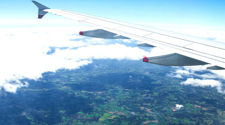 Clouds over England landscape from the big airplaine window with soft focus