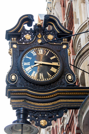 An old London street clock at dusk time, London, UK
