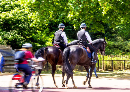 Police women on horseback on  The Mall, street in front of Buckingham Palace in London