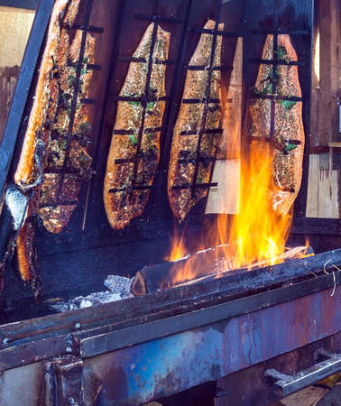 Cooking Salmon on the grill at the Christmas market in Baden-Badenの写真素材