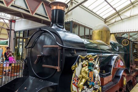 Copy of  Royal train stream  locomotive "The Queen", series of GWR,  3041 1894-1912, with  heraldic symbols of  state  on board  on train station    A copy made in 1982.  Suchlike locomotive carried the royal family on vacation from London to  summer resiのeditorial素材