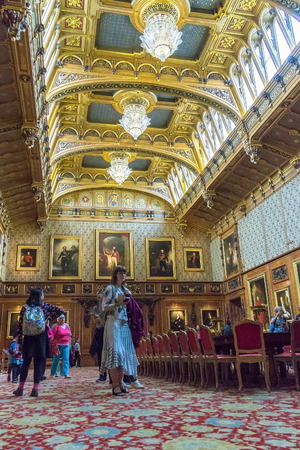 Unidentified visitors inside royal palace in medieval Windsor Castle. Windsor Castle is a royal residence at Windsor in the English county of Berkshire. It was built in 1066 by William the Conqueror and it is the longest-occupied palace in Europe. UKのeditorial素材