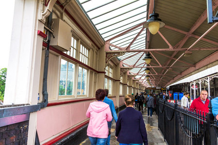Unidentified  tourists and passengers at  Windsor train station. UK