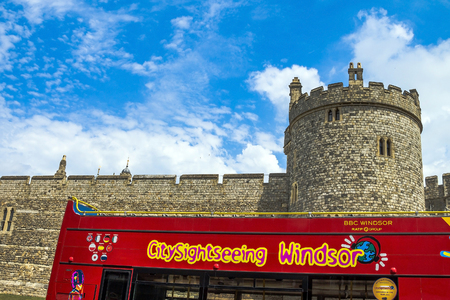 Red tourist bus near  Lower Ward in medieval Windsor Castle. Windsor Castle is a royal residence at Windsor in the English county of Berkshire.のeditorial素材