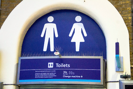 White lady and man toilet sign on blue background  at Charing Cross railway station. London. UKのeditorial素材