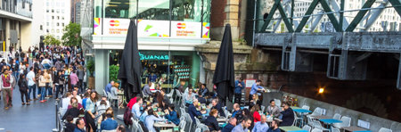 LONDON, UK - JUNE 6, 2015:  Unidentified people at outdoor fast food restaurant on the south bank of...
