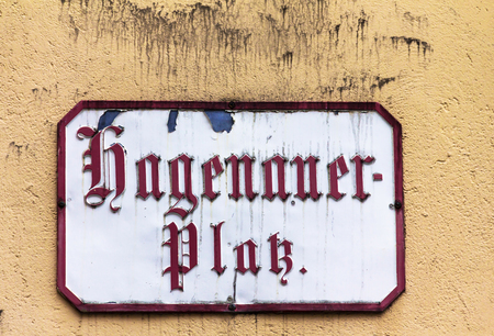 Salzburg, Austria- July 15, 2017: Hagenau Square sign on the plastered wall. It is probably one of the most famous squares in Salzburg. Mozart Birthplace actually found on Hagenau Squareのeditorial素材