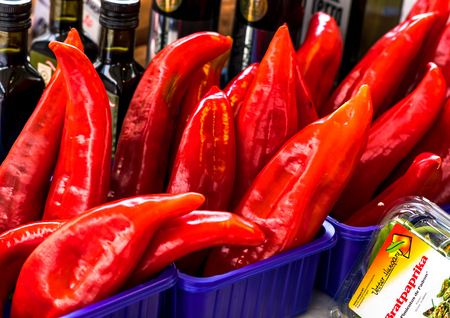 Salzburg, Austria -July 15, 2017: Red peppers in plastic box on city street marketのeditorial素材