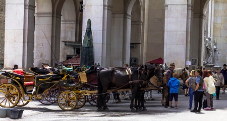 Salzburg, Austria -July 15, 2017: Carriages with harnessed horses are waiting for tourists on Residenzplatz(Residence square) near Salzburg Cathedralのeditorial素材