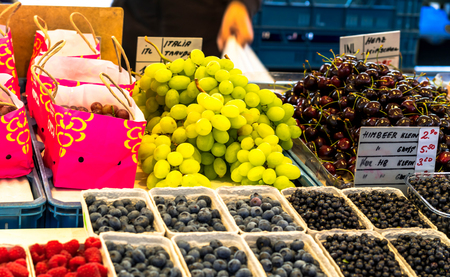 Salzburg, Austria -July 15.2017: Green grapes, cherry and blueberry at City Fruit and Vegetable Market. Selective focusのeditorial素材