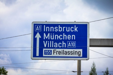 Traffic sign of direction to 1 highways in the Innsbruck, Munich,Munchen, Villach, Freilassing on cloudy summer sky background. Salzburg, Austriaの写真素材