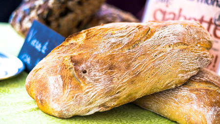 Salzburg, Austria - June 1, 2017: Freshly baked bread from rye flour for sale on Schrannenmarkt, a traditional market on Mirabellplatz.のeditorial素材