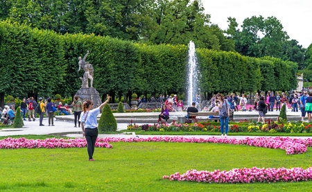 Salzburg, Austria - July 15,2017: Young girl makes photo for memory. Mirabell garden is the most...