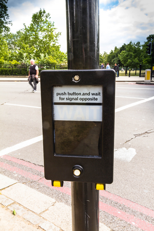 LONDON, UK - JUNE 9, 2015: Crosswalk button for pedestrian with light warning. London. UKのeditorial素材