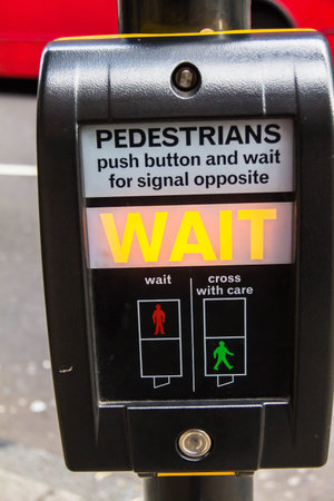 Crosswalk button for pedestrian with light warning. London. UK