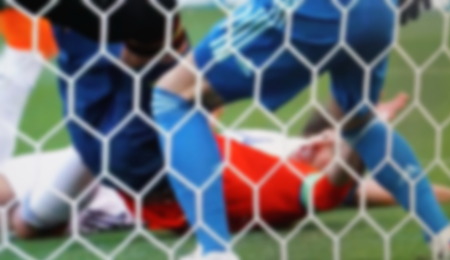 Football. Falling forward after a goal scored to the opponent. Blurred viewの写真素材