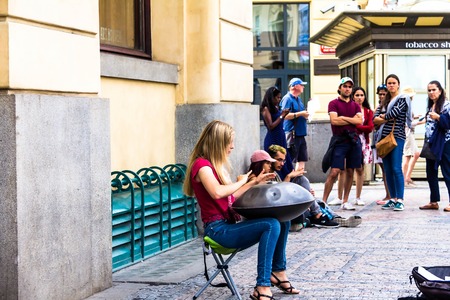 Prague, Czech Republic -July 23,2017: Young woman playing on a first generationan instrument called '' Hang '' or ''Hang drum''のeditorial素材