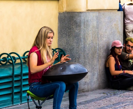 Prague, Czech Republic -July 23,2017: Young woman playing on a first generationan instrument called '' Hang '' or ''Hang drum''のeditorial素材