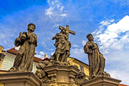PRAGUE, CZECH REPUBLIC. Sculpture of Holy Savior with Cosmas and Damian on the Charles Bridge in Prague. Czech Republic. Saints Cosmas and Damian squeeze bottles of medicines that treat for freeのeditorial素材