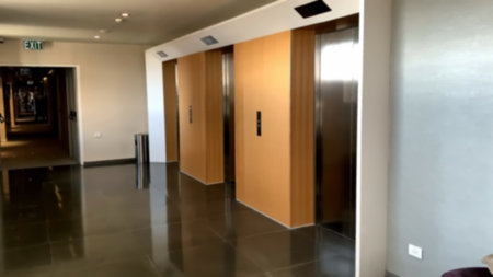 Modern steel elevator cabins in a business lobby or Hotel. Blurred view