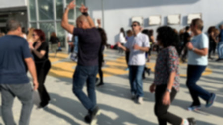 Unidentified citizens dancing traditional Israeli dances on Tel Aviv Promenade. Blurred view