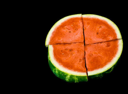 Slices of red ripe sweet watermelon on black background, closeup , selective focusの写真素材