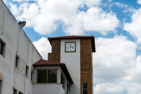 White clock tower on blue cloudy sky backgroundの写真素材