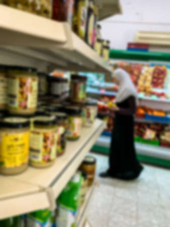 Unidentified Circassian Muslim woman in traditional casual national dress at a grocery store in Circassian - Adyghe village Kfar Kama, located near the Nazareth in the Galilee, in northern Israel. Blurred viewの写真素材