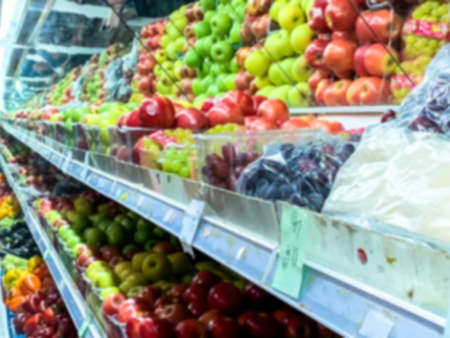 Assortment of fresh raw of green, red, yellow apples on counter in the supermarket. Blurred viewの写真素材