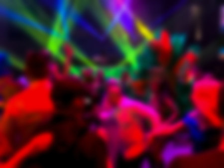 Dancing people at a party. Entertainment program at the wedding. Silhouettes of people dancing at a party. Blurred viewの写真素材
