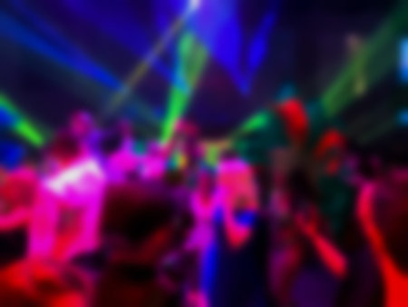 Dancing people at a party. Entertainment program at the wedding. Silhouettes of people dancing at a party. Blurred viewの写真素材