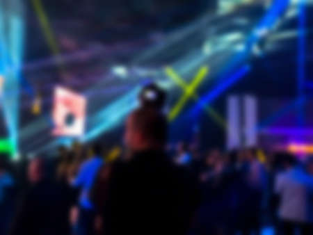 Silhouette of the photographer at a dancing party. Entertainment program at the wedding. ?eople dancing at a party. Blurred viewの写真素材