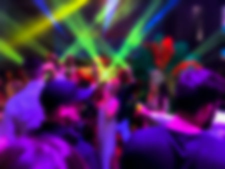 Dancing people at a party. Entertainment program at the wedding. Silhouettes of people dancing at a party. Blurred viewの写真素材