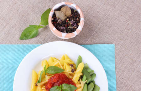 Pasta, sauce, green basil and cheese. Top view of a plate of pasta. The Italian national dish, Italian cuisine. Tasty and healthy lunchの写真素材