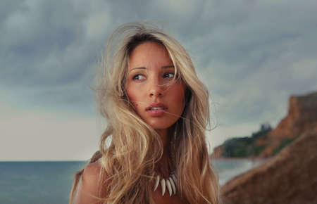 Time before storm. Girl is waiting for massive rain at the sea beachの写真素材