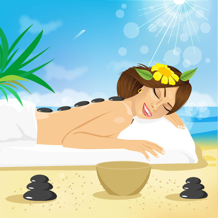 Beautiful brunette woman getting hot stones treatment out on the beachのイラスト素材