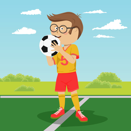 Teenager boy with glasses poses with soccer ball on fieldのイラスト素材