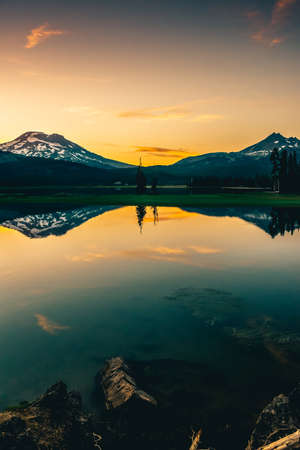 A mountain at sunset with the reflection in the lakeの写真素材