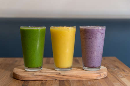 Smoothies in glass on wooden background. Healthy food concept.の写真素材