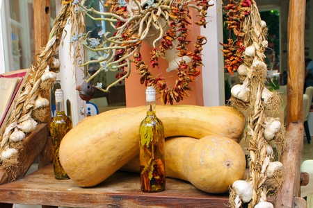 Two pumpkins, garlic bundles, vegetables and alcohol tinctures on medicinal herbs in bottlesのeditorial素材