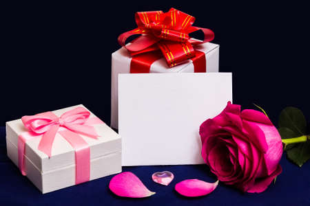 Gift boxes with bows for Valentine`s Day, Weddings or Birthday. Rose petals. Dark background. Copy space.の写真素材