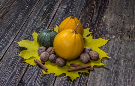 Autumn pumpkins with leaves on wooden boards. Thanksgiving Day. Harvest.の写真素材