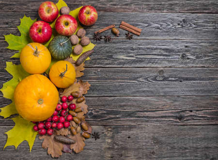 Pumpkins and apples on the wooden table. Flat lay.の写真素材