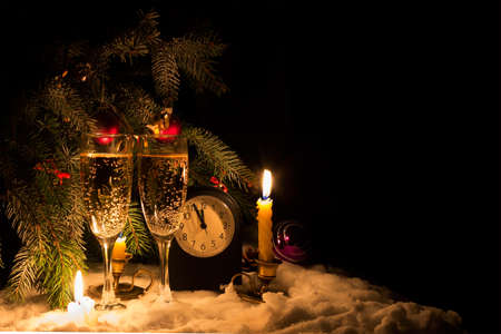 New year's night. Five to twelve on the clock. Champagne and wine glasses.の写真素材