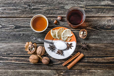 A traditional hot mulled wine. A glass of mulled wine and a plate with a lemon. View from above.の写真素材