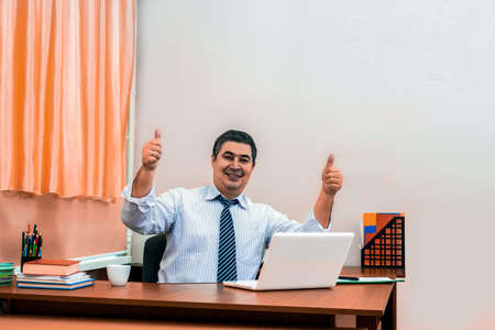 Successful mature male businessman. Thumbs up! All perfectly!の写真素材