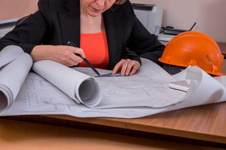 Female designer draws a drawing. Project development. Plan.の写真素材